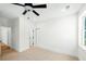 Light-filled bedroom with neutral carpet, modern ceiling fan, and views to hallway and closet at 2725 Starfish Dr, Johns Island, SC 29455
