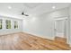 Spacious bedroom with wood floors, three windows, modern ceiling fan, and walk-in closet at 2725 Starfish Dr, Johns Island, SC 29455