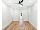 Open bedroom with hardwood floors, bright white walls, and open doorway to adjoining room at 2725 Starfish Dr, Johns Island, SC 29455