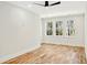 Bright bedroom with hardwood floors, three windows, and modern ceiling fan at 2725 Starfish Dr, Johns Island, SC 29455