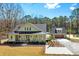An exterior view captures the house and detached garage, emphasizing the green exterior and surrounding landscaping at 2725 Starfish Dr, Johns Island, SC 29455