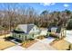 An exterior shot of a light green house and detached garage with fresh landscaping and a long driveway at 2725 Starfish Dr, Johns Island, SC 29455