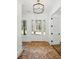 Bright foyer with brick floors, modern light fixture, and white trim throughout at 2725 Starfish Dr, Johns Island, SC 29455