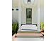 Inviting front door framed by white columns and lush green plantings at 2725 Starfish Dr, Johns Island, SC 29455