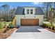 Detached garage with guest suite features a wooden garage door and convenient side stairs at 2725 Starfish Dr, Johns Island, SC 29455