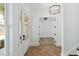 Hallway with brick floors leading to rooms filled with natural light and white trim at 2725 Starfish Dr, Johns Island, SC 29455