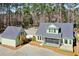 Aerial view of a light green home with a detached garage and a screened in porch at 2725 Starfish Dr, Johns Island, SC 29455