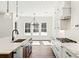 Bright kitchen with white cabinets, stainless steel appliances, pendant lights, and marble countertops at 2725 Starfish Dr, Johns Island, SC 29455
