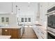 Bright kitchen with white cabinets, stainless steel appliances and marble countertops at 2725 Starfish Dr, Johns Island, SC 29455