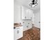 A laundry room features granite countertops, ample storage, and space-saving design at 2725 Starfish Dr, Johns Island, SC 29455