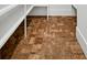 Walk-in pantry featuring brick-style tile flooring and white shelving at 2725 Starfish Dr, Johns Island, SC 29455