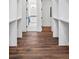 Spacious walk-in closet with white shelving and wood floors leading to other rooms at 2725 Starfish Dr, Johns Island, SC 29455