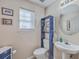 Half bathroom with pedestal sink and decorative shelving at 2755 Lacy St, North Charleston, SC 29406