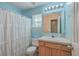 Bright bathroom with a single sink vanity, a window, and a white shower curtain at 2755 Lacy St, North Charleston, SC 29406