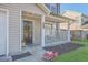 Inviting front porch with seating, a decorative wreath, and meticulous landscaping for a cozy entrance at 2755 Lacy St, North Charleston, SC 29406