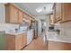 Cozy kitchen features wooden cabinetry, white appliances, and views to the laundry room at 2755 Lacy St, North Charleston, SC 29406