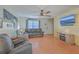 Comfortable living room with ceiling fan, wood laminate flooring, and modern media center at 2755 Lacy St, North Charleston, SC 29406