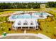 Aerial view of the splashpad, playground, community pool and resident center with covered lounge areas at 284 Watersglen Dr, Summerville, SC 29486