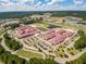 Aerial view of a school with athletic fields and parking nestled among lush green trees at 341 Iveson Rd, Summerville, SC 29486