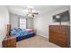 This bedroom features carpeted floors, a ceiling fan, and a large dresser for storage at 341 Iveson Rd, Summerville, SC 29486