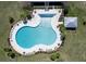 Aerial view of a uniquely shaped pool with seating areas, lush landscaping, and shade at 341 Iveson Rd, Summerville, SC 29486