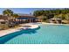 Community center showcases a large pool, cabana with seating and lush palm trees at 341 Iveson Rd, Summerville, SC 29486