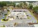 Aerial view of a retail building with ample parking and convenient gas station, surrounded by lush greenery at 341 Iveson Rd, Summerville, SC 29486