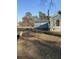 Fenced backyard with partial view of blue house, mature trees, and outbuildings at 342 Early Ln, Summerville, SC 29486