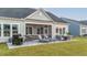 Outdoor patio with a built-in grill, screened-in porch, comfortable lounge chairs, and an outdoor dining set at 357 Tupelo Lake Dr, Summerville, SC 29486
