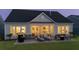 Backyard view of house with well-maintained lawn, a stone paver patio with outdoor furniture, and lake view at 357 Tupelo Lake Dr, Summerville, SC 29486