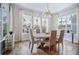 Dining room with hardwood floors, windows and view of exterior greenery, plus modern style lighting at 357 Tupelo Lake Dr, Summerville, SC 29486