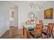 Bright dining room featuring modern chandelier, decorative mirror, and seating for six near built in sideboard at 357 Tupelo Lake Dr, Summerville, SC 29486