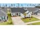 The home's pleasing exterior is complimented by a lush lawn, mature palm tree, and a lengthy driveway at 357 Tupelo Lake Dr, Summerville, SC 29486