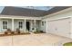 The inviting front exterior features a covered porch, attached garage, and neatly arranged landscaping at 357 Tupelo Lake Dr, Summerville, SC 29486