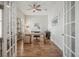 Home office featuring French doors, modern ceiling fan, and a desk with shelving at 357 Tupelo Lake Dr, Summerville, SC 29486