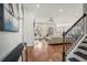 Open-concept living room with hardwood floors, a staircase, and a view to the bright living area at 357 Tupelo Lake Dr, Summerville, SC 29486