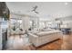 Spacious living room features hardwood floors, large windows, and a fireplace, seamlessly connecting to the kitchen at 357 Tupelo Lake Dr, Summerville, SC 29486