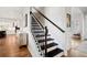 Elegant staircase featuring dark wood steps, iron spindles, and a bright, inviting entrance at 357 Tupelo Lake Dr, Summerville, SC 29486