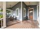 Covered front porch with seating, views of the street, and a hanging lantern at 3699 Codorus Ct, Mount Pleasant, SC 29466