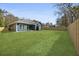 Wide shot of the backyard, showing the blue siding, deck, green grass and privacy fence at 39 Briarcliff Dr, Charleston, SC 29407