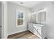 Bright bathroom with shiplap accent wall, double sink vanity, and wood-look flooring at 39 Briarcliff Dr, Charleston, SC 29407
