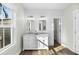 Bathroom featuring shiplap accent wall, dual sink vanity, and wood-look floors at 39 Briarcliff Dr, Charleston, SC 29407