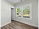 Light filled bedroom with wood look floors, white ceilings and walls, and window overlooking a backyard at 39 Briarcliff Dr, Charleston, SC 29407