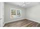 Bedroom with wood-look floors, neutral walls, ceiling fan, and a window providing natural light at 39 Briarcliff Dr, Charleston, SC 29407