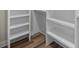 Bright walk-in closet with custom built-in shelving and wood-look flooring at 39 Briarcliff Dr, Charleston, SC 29407