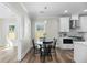 Eat in kitchen area featuring black chairs, with white cabinetry and stainless appliances at 39 Briarcliff Dr, Charleston, SC 29407