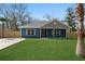 Charming blue home featuring a well-manicured lawn, grey roof and complimentary shutter accents at 39 Briarcliff Dr, Charleston, SC 29407