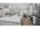 Bright kitchen with white cabinets, quartz countertops, stainless appliances, and a view of a modern fireplace at 39 Briarcliff Dr, Charleston, SC 29407