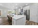Modern kitchen island with bar stool seating, stainless appliances, and sleek white cabinetry at 39 Briarcliff Dr, Charleston, SC 29407