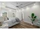 Spacious main bedroom with wood-look floors, tray ceiling with fan, and large windows providing natural light at 39 Briarcliff Dr, Charleston, SC 29407